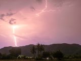 a lightning bolt hitting over a mountain range