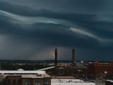 a storm moving across the sky over a city