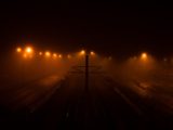 a train track with a foggy sky above