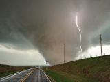 a large storm is coming down on a highway