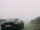 black bmw car on green grass field during daytime