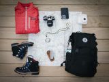black hiking backpack near white Fujifilm instax mini camera near black leather boots, red half-zip jacket, gray pocket watch on white map