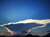 A dramatic lenticular cloud formation against a blue sky