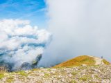 a person walking on a rocky hill