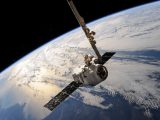 A satellite glides over Earth showcasing dramatic cloud formations and the vast expanse of space.