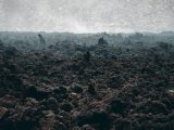 a large pile of dirt in the middle of a field