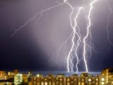 thunder on body of water near buildings