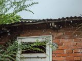 rain pouring on brick wall house