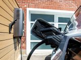 Electric car charging station on a wooden wall