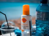 white and orange plastic bottle on blue table