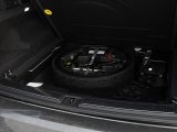 Spare tire and tools in car trunk