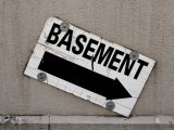 a sign on the side of a building that says basement