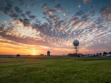 Sunset over a weather station in Norman, Oklahoma, with dramatic sky and clouds.