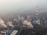Aerial shot of an industrial plant in Poznań emitting smoke and pollution.
