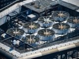 Industrial cooling fans on a rooftop.