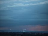 city skyline under cloudy sky during night time