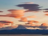 Captivating sunset over a distant mountain with dramatic cloud formations.