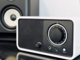 Close-up of a modern radio and speaker setup, showcasing audio equipment design.