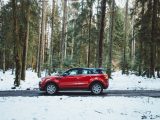 red suv on snow covered road during daytime