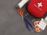 A comprehensive first aid kit with essential medical tools and supplies for emergencies.