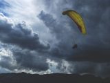 a person in the air with a parachute