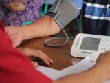 a person with a blood pressure meter on a table