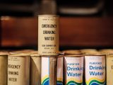 Several cans of drinking water stacked on top of each other