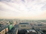 Stunning aerial view of Warsaw's skyline on a cloudy day with urban buildings and sprawling cityscape.