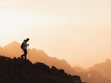a couple of people standing on top of a mountain