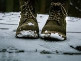 pair of brown leather boots on snow