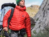man looking above carrying gray camping backpack