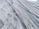 From above of rural road covered with snow and frost in cold winter day
