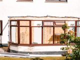 Conservatory under construction with boarded up windows