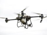 High-resolution image of a specialized agricultural drone flying outdoors, showcasing modern farming technology.