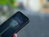 A person holding a cell phone in their hand