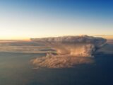 Breathtaking aerial view of a towering cumulonimbus cloud during sunset.