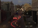 Car lights create a trail on a city street