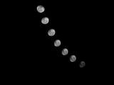 Black and white photo showing the phases of the moon against a dark night sky, creating a celestial scene.