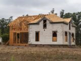 Image of an old house under renovation with new wooden frame structure.