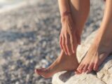 person foot on brown rock