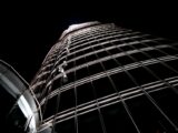 A striking upward shot of the Burj Khalifa's illuminated facade against the night sky in Dubai.