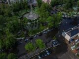 Aerial shot of a flooded city park and surrounding streets after a storm.